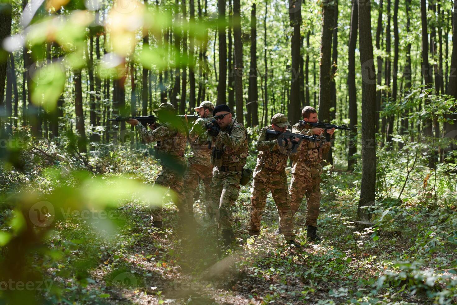 A specialized military antiterrorist unit conducts a covert operation in dense, hazardous woodland, demonstrating precision, discipline, and strategic readiness photo