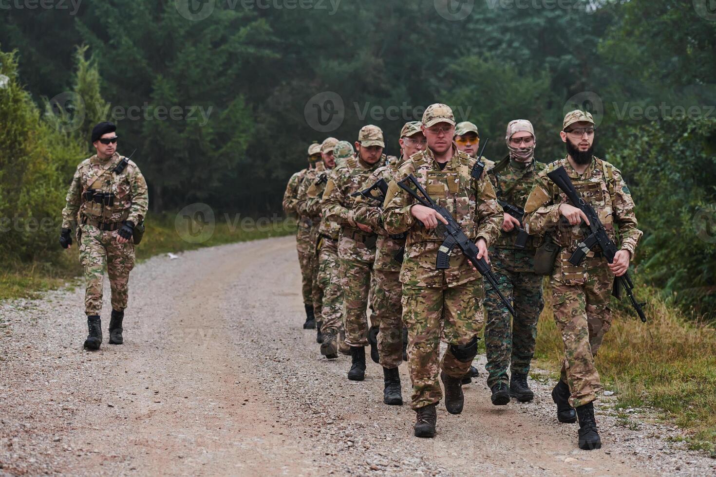 An elite military unit, led by a major, confidently parades through dense forest, showcasing precision, discipline, and readiness for high-risk operations photo