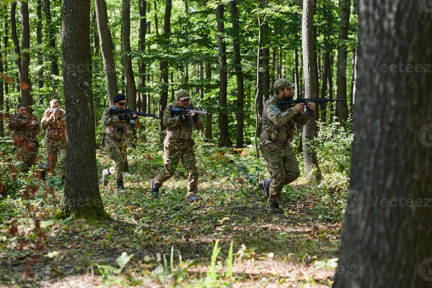 A specialized military antiterrorist unit conducts a covert operation in dense, hazardous woodland, demonstrating precision, discipline, and strategic readiness photo