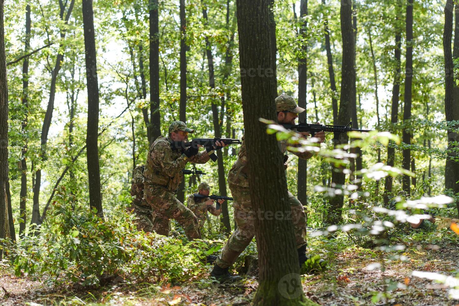 A specialized military antiterrorist unit conducts a covert operation in dense, hazardous woodland, demonstrating precision, discipline, and strategic readiness photo
