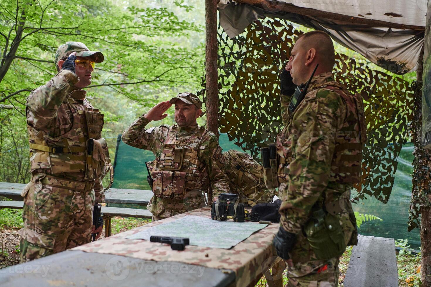 A highly trained military unit strategizes and organizes a tactical mission while studying a military map during a briefing session photo