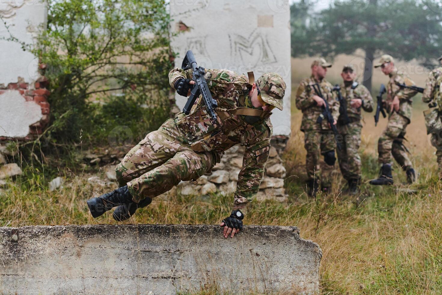 A highly trained elite military unit, clad in camouflage, skillfully navigates through perilous forest terrain, overcoming obstacles and executing a precise and covert mission photo