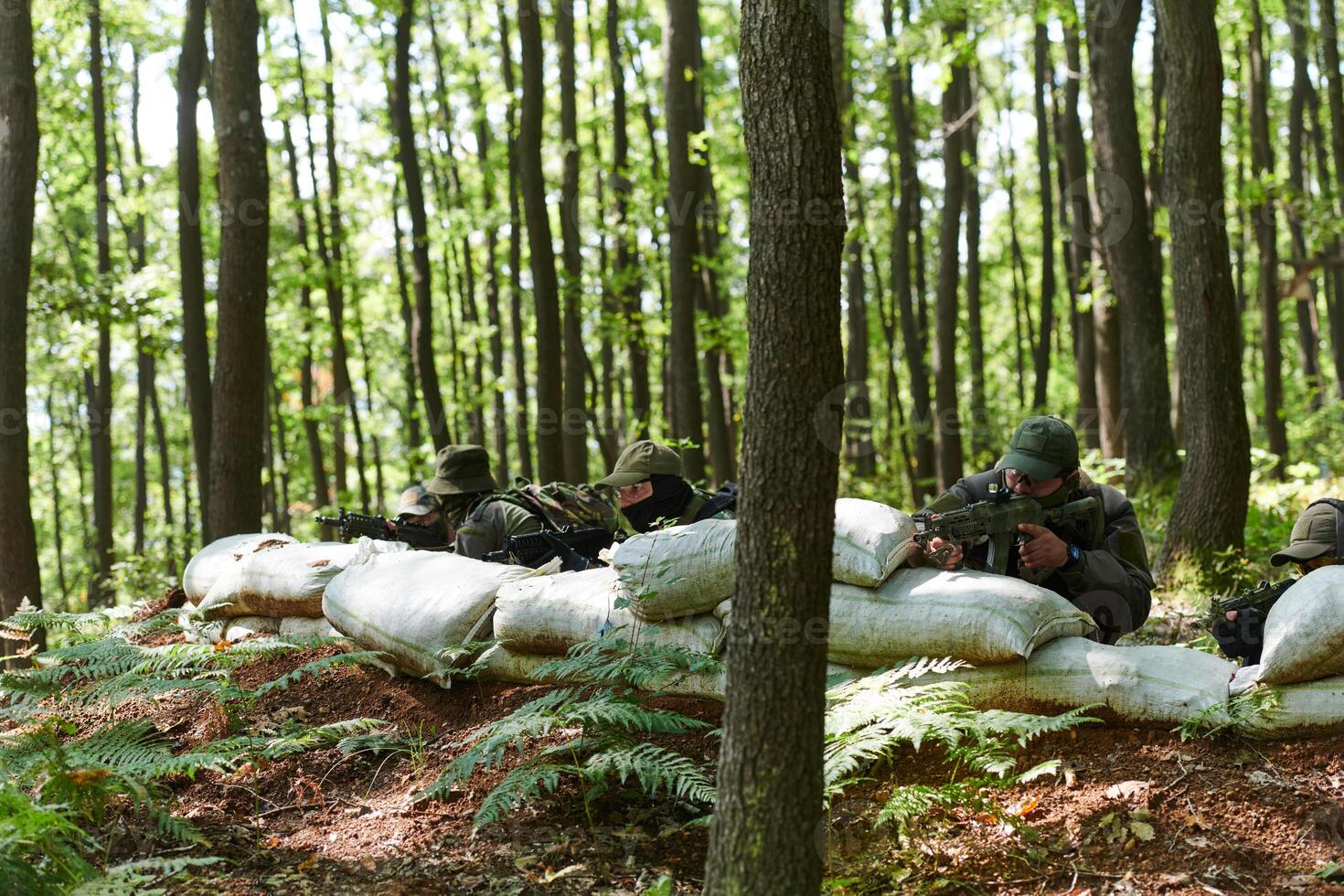 A disciplined and specialized military unit, donned in camouflage, strategically patrolling and maintaining control in a high-stakes environment, showcasing their precision, unity, and readiness for photo