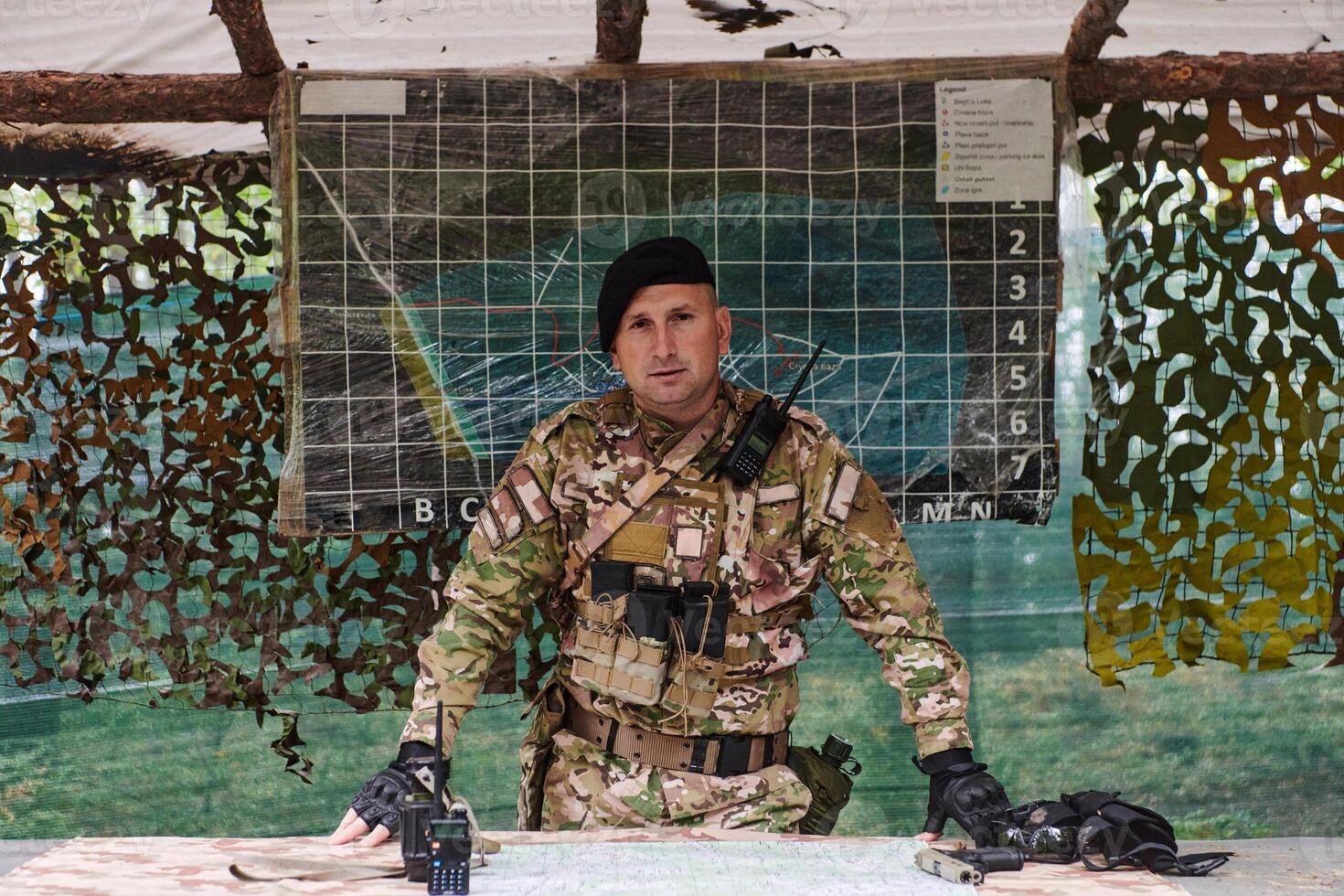 The esteemed leader of an elite military unit, strategic brilliance unfolds as he meticulously devises tactical plans for the upcoming military operation, surrounded by cutting-edge technology and a photo
