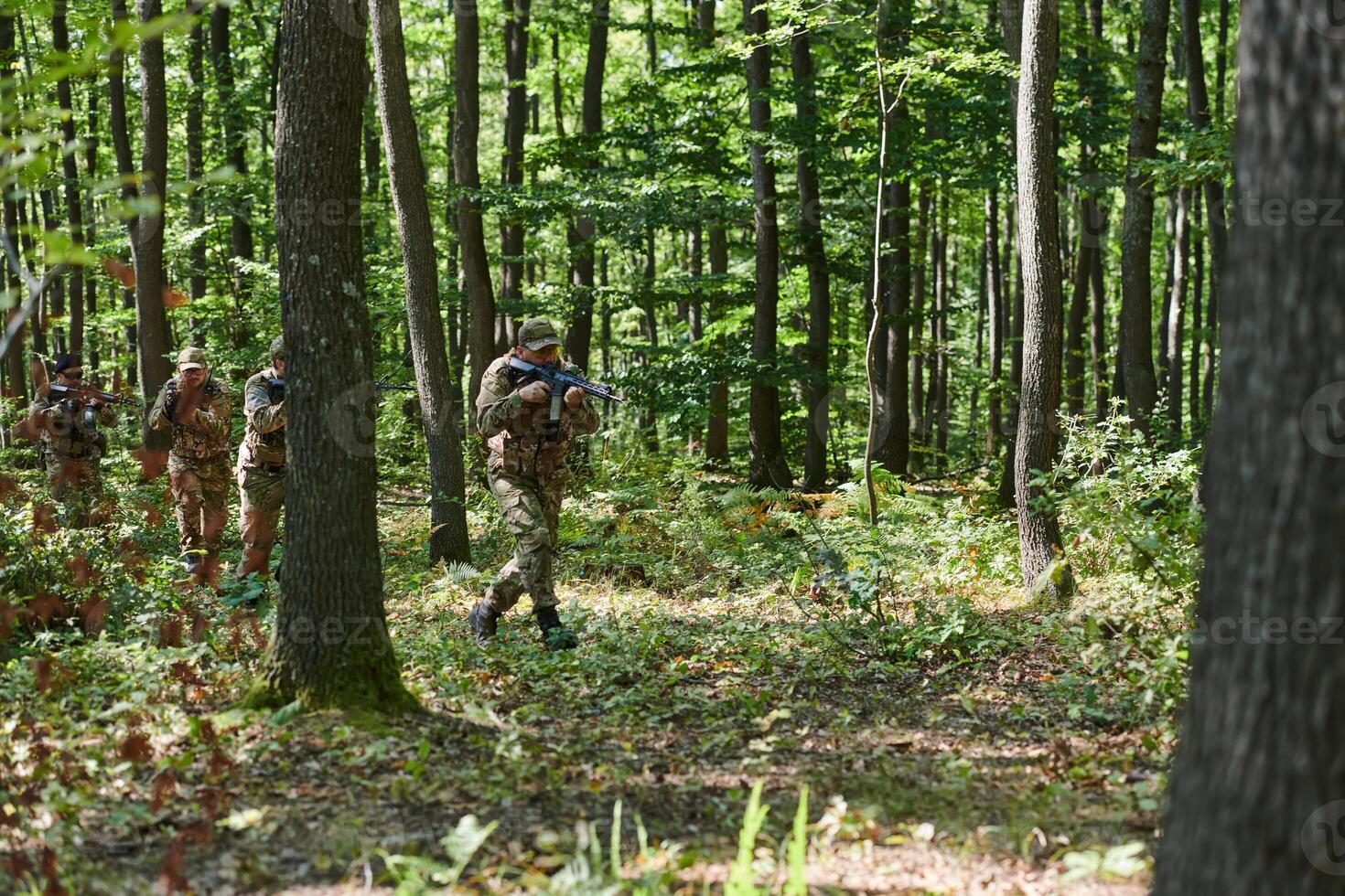 A specialized military antiterrorist unit conducts a covert operation in dense, hazardous woodland, demonstrating precision, discipline, and strategic readiness photo