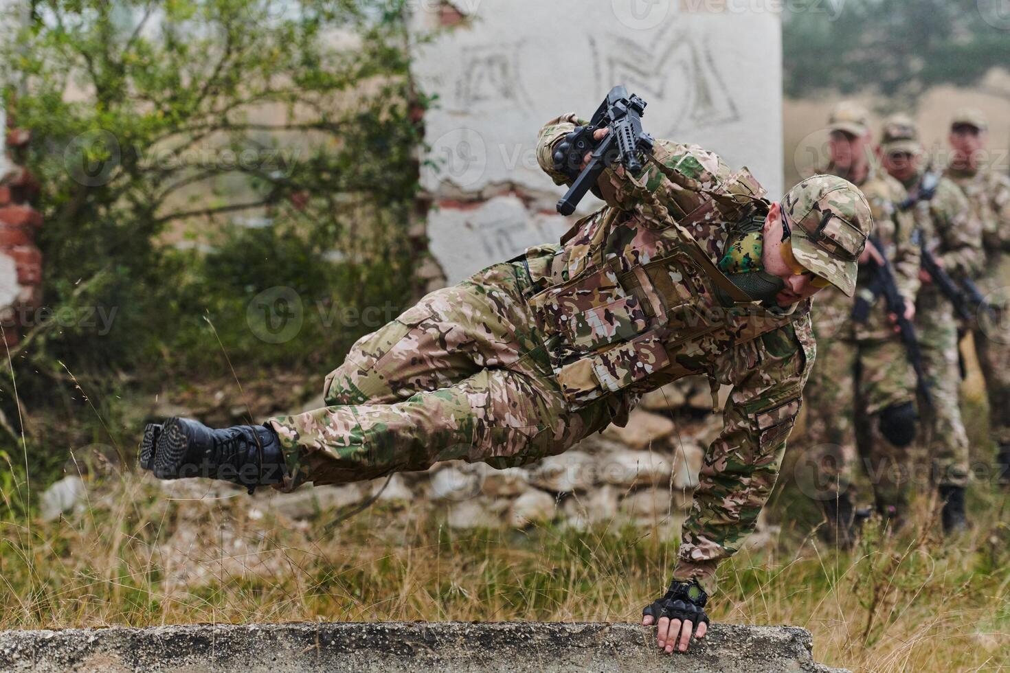 A highly trained elite military unit, clad in camouflage, skillfully navigates through perilous forest terrain, overcoming obstacles and executing a precise and covert mission photo