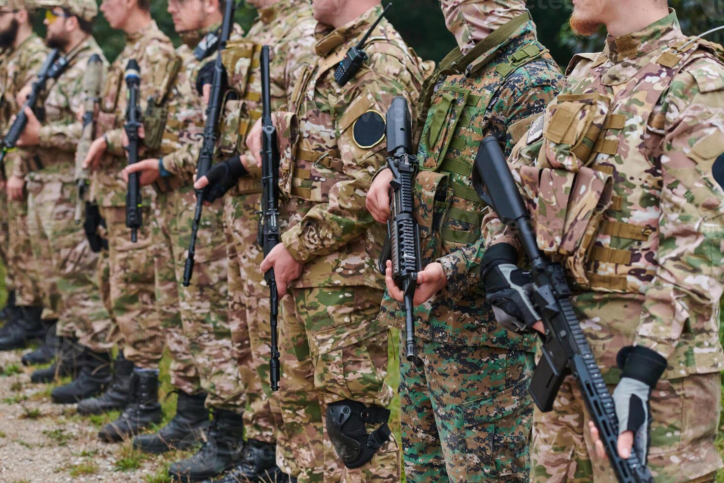 Soldier fighters standing together with guns. Group portrait of US army elite members, private military company servicemen, anti terrorist squad photo