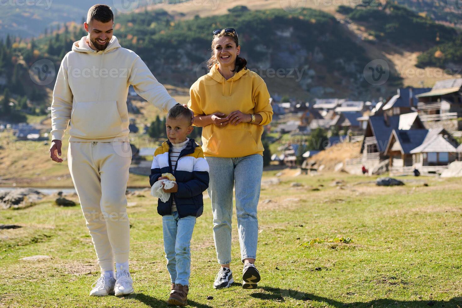 A modern family, along with their son, revels in the joy of a muddy day in nature, running and playing together, encapsulating the beauty of a healthy and active lifestyle photo