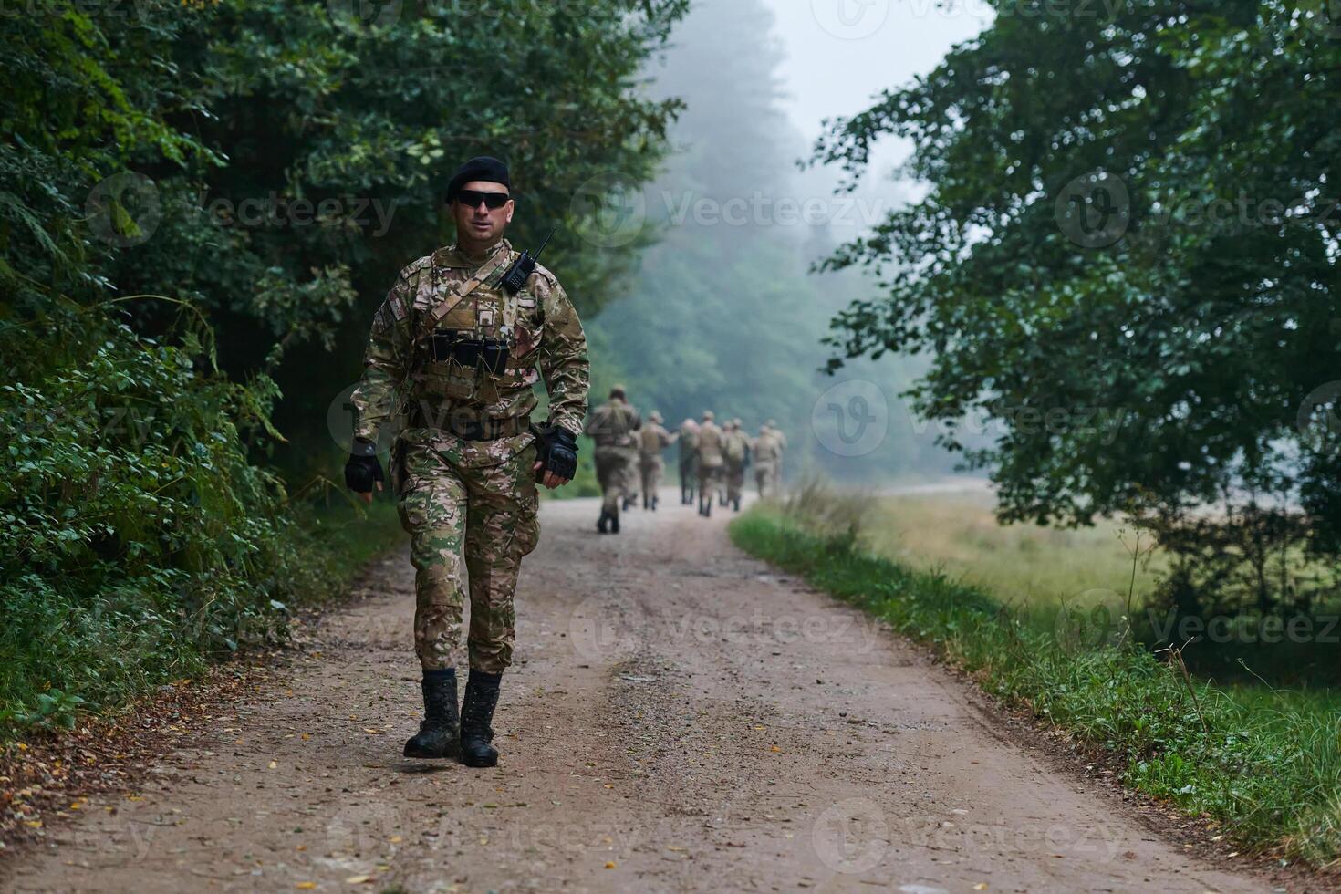 A group of elite soldiers leads captives through a military camp, showcasing a tense atmosphere of detention and security operations photo
