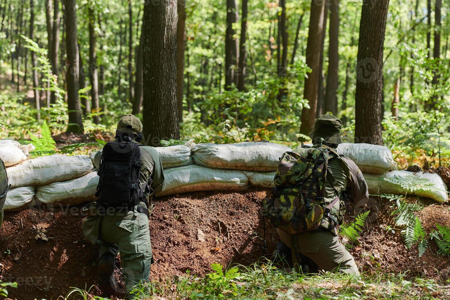 two elite soldiers stand guard, resolute and vigilant, defending the area against attacking enemies with tactical precision and unwavering determination, showcasing their role as skilled protectors in photo