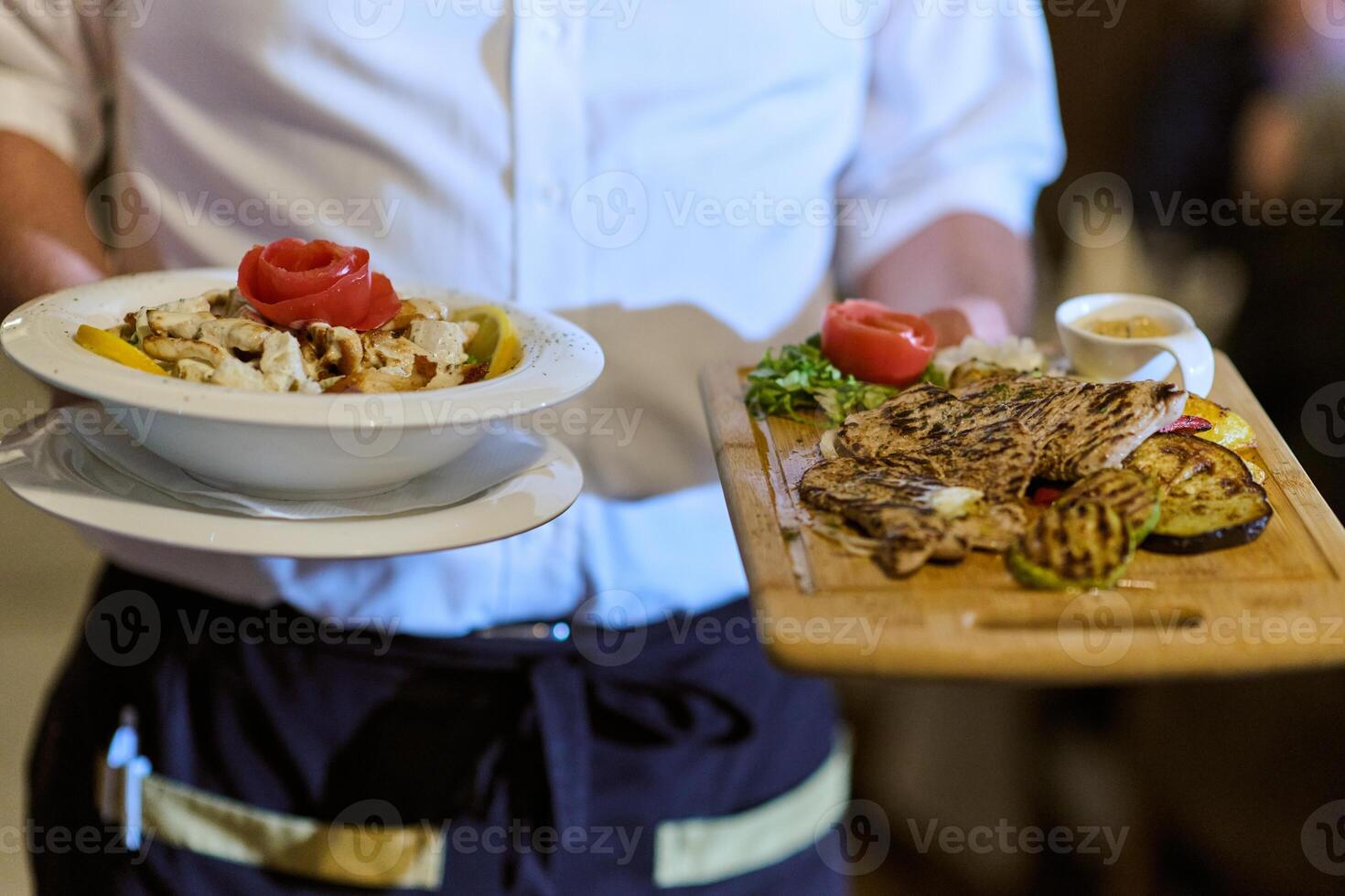 A courteous waiter provides impeccable service to an elderly family and their friends, creating a convivial atmosphere as they gather for a shared lunch, indulging in the diverse and delectable photo