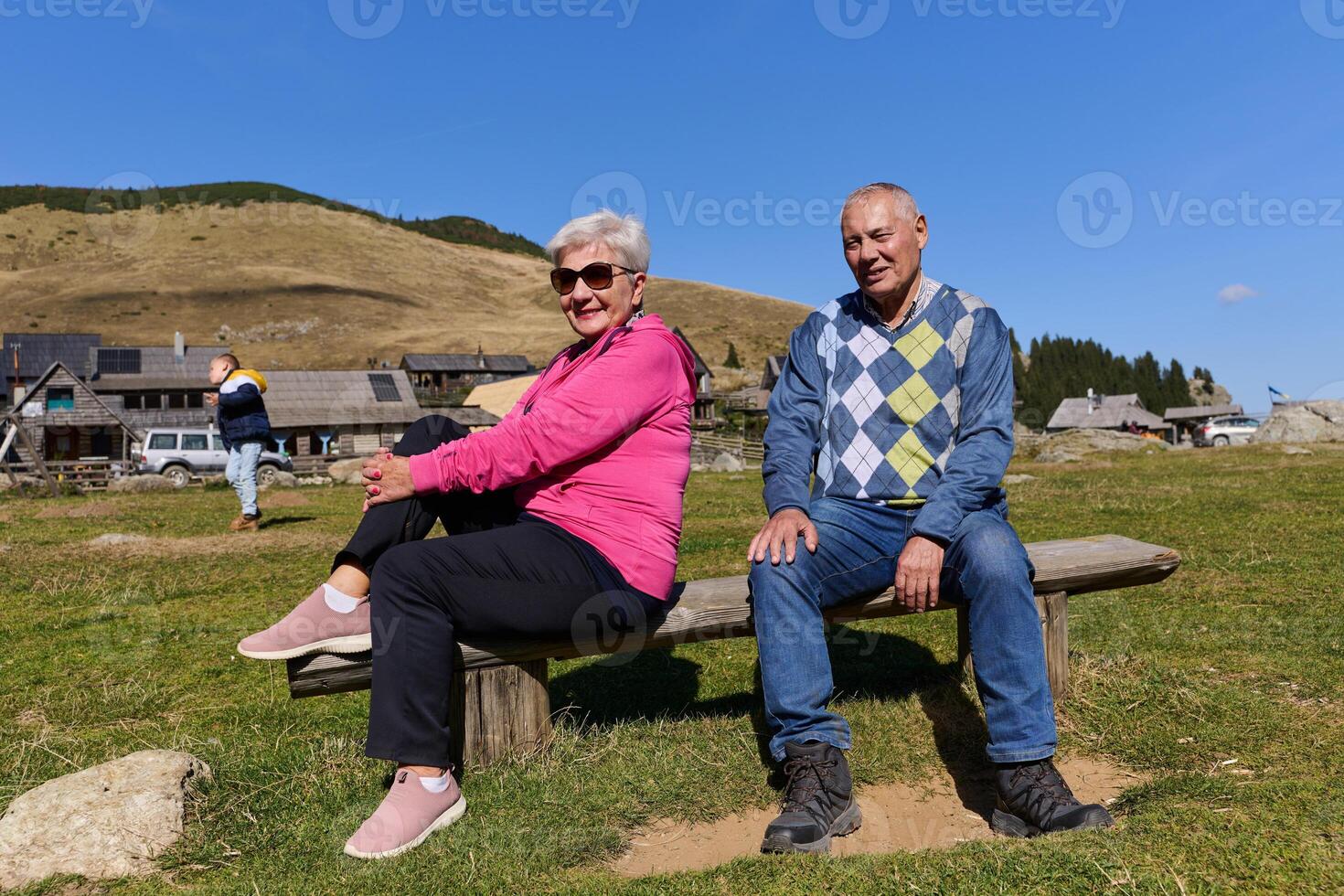 Elderly couple finding solace and joy as they rest on a park bench, engaged in heartfelt conversation, following a rejuvenating strol a testament to the enduring companionship and serene connection photo