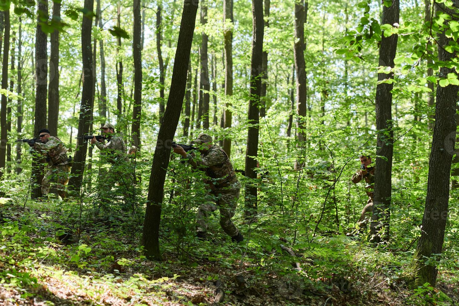 A specialized military antiterrorist unit conducts a covert operation in dense, hazardous woodland, demonstrating precision, discipline, and strategic readiness photo