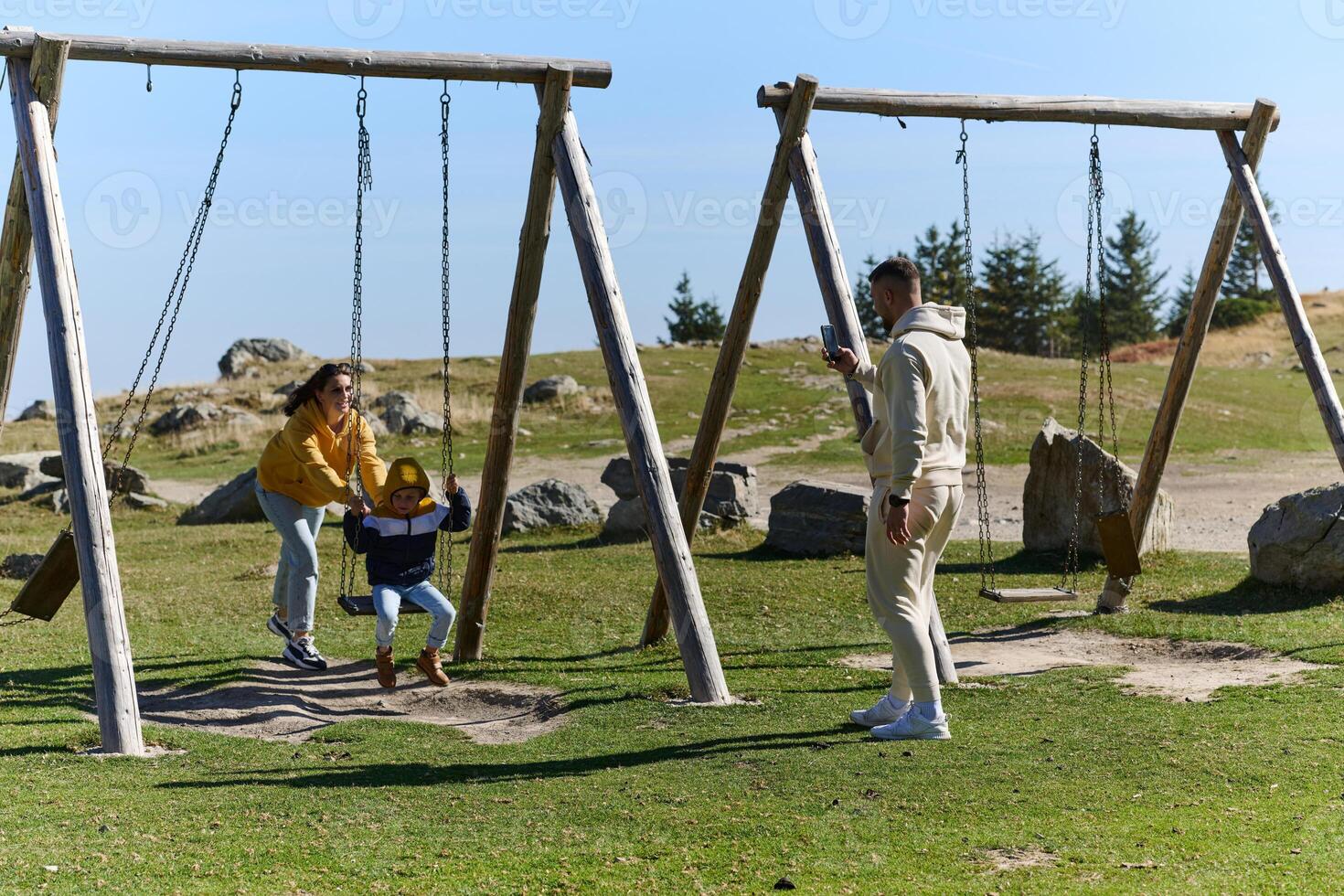 A modern family, along with their son, revels in the joy of a muddy day in nature, running and playing together, encapsulating the beauty of a healthy and active lifestyle photo