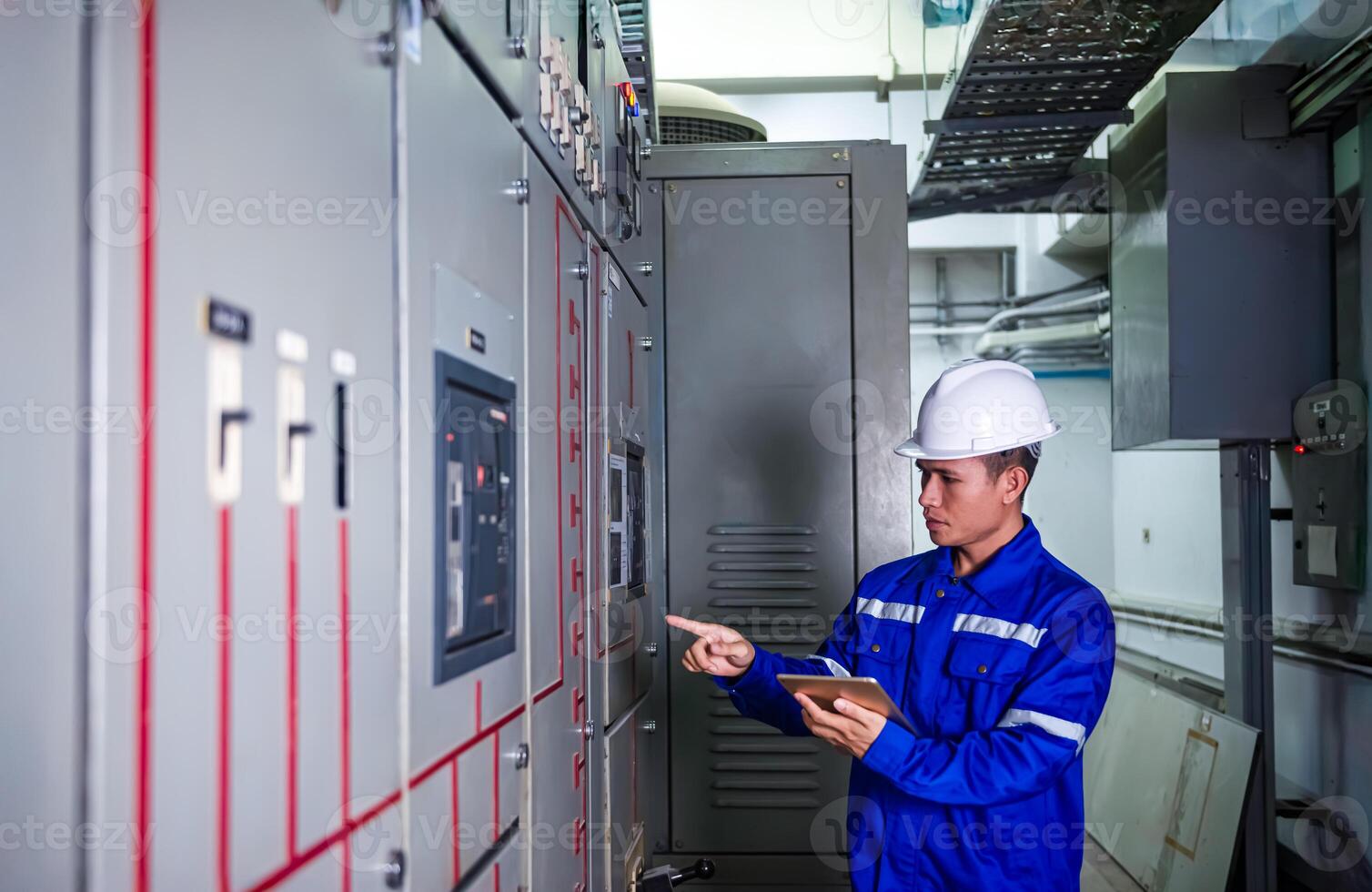 electrical engineer check the operation of the main electrical control panels photo