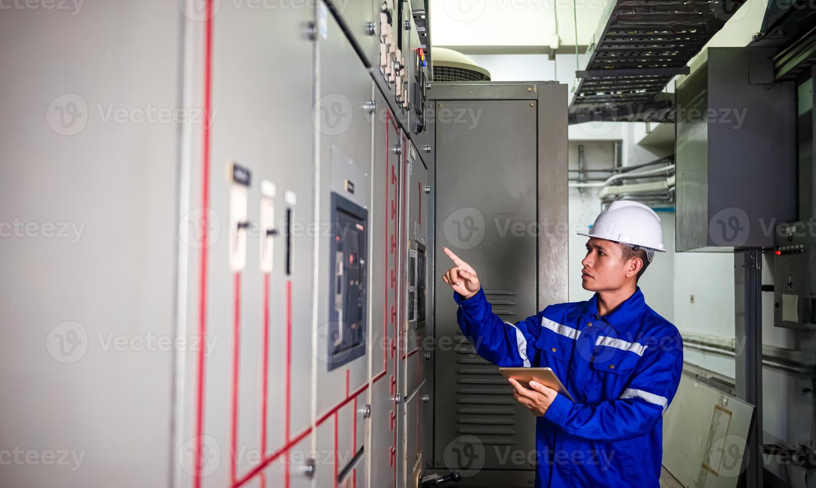 electrical engineer check the operation of the main electrical control panels photo