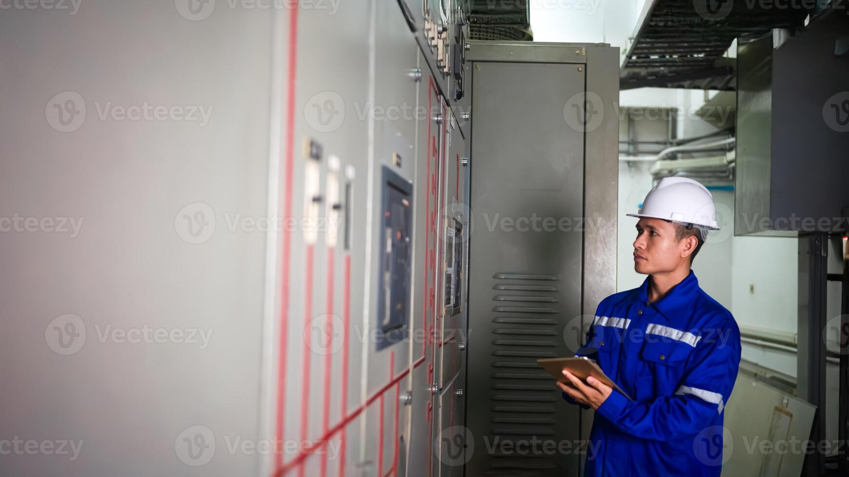 electrical engineer check the operation of the main electrical control panels photo