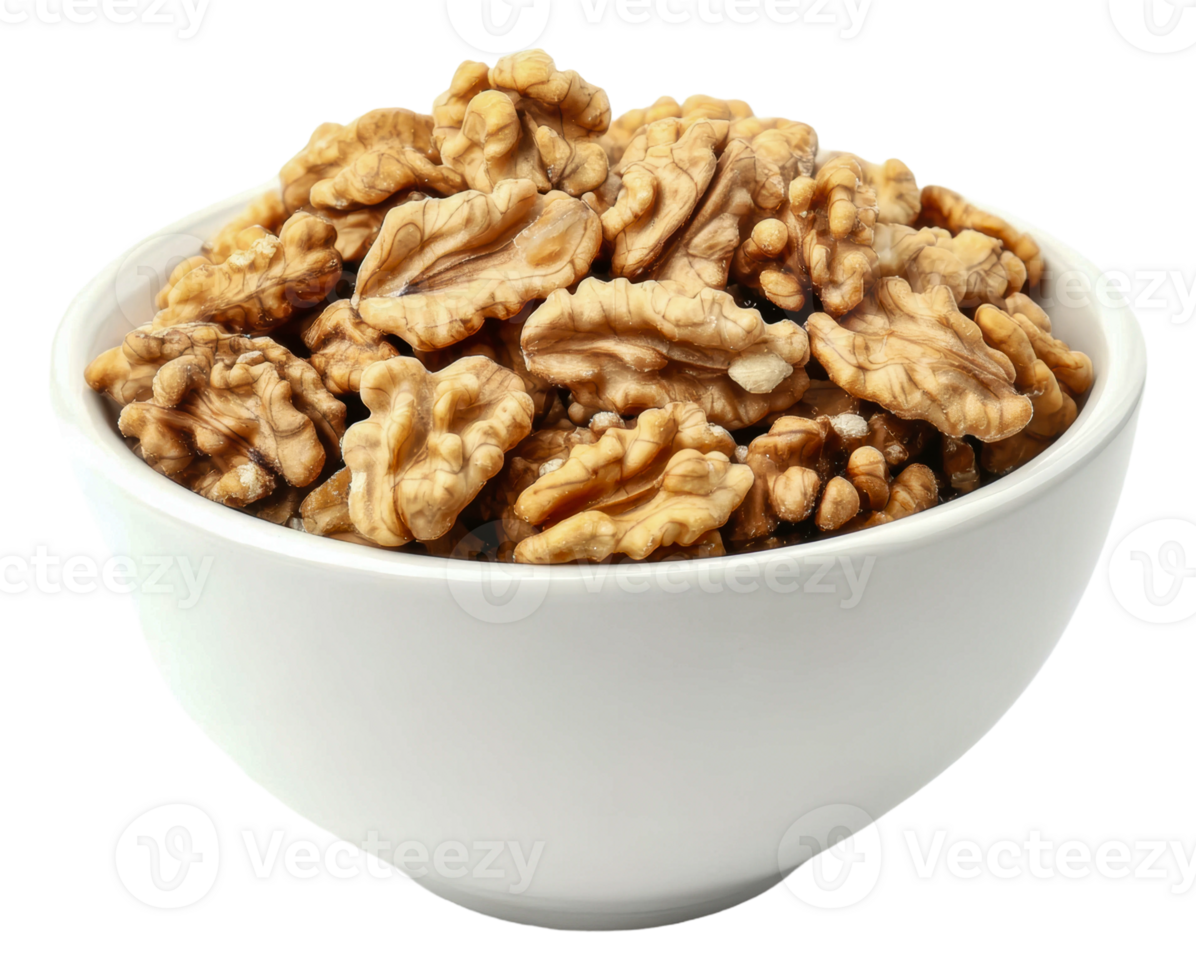 Freshly shelled walnuts in a white bowl on table png