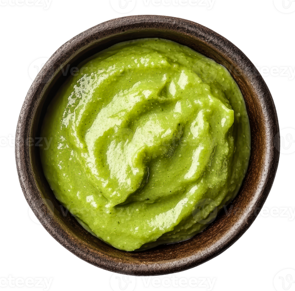 Creamy green sauce in a wooden bowl on a table png