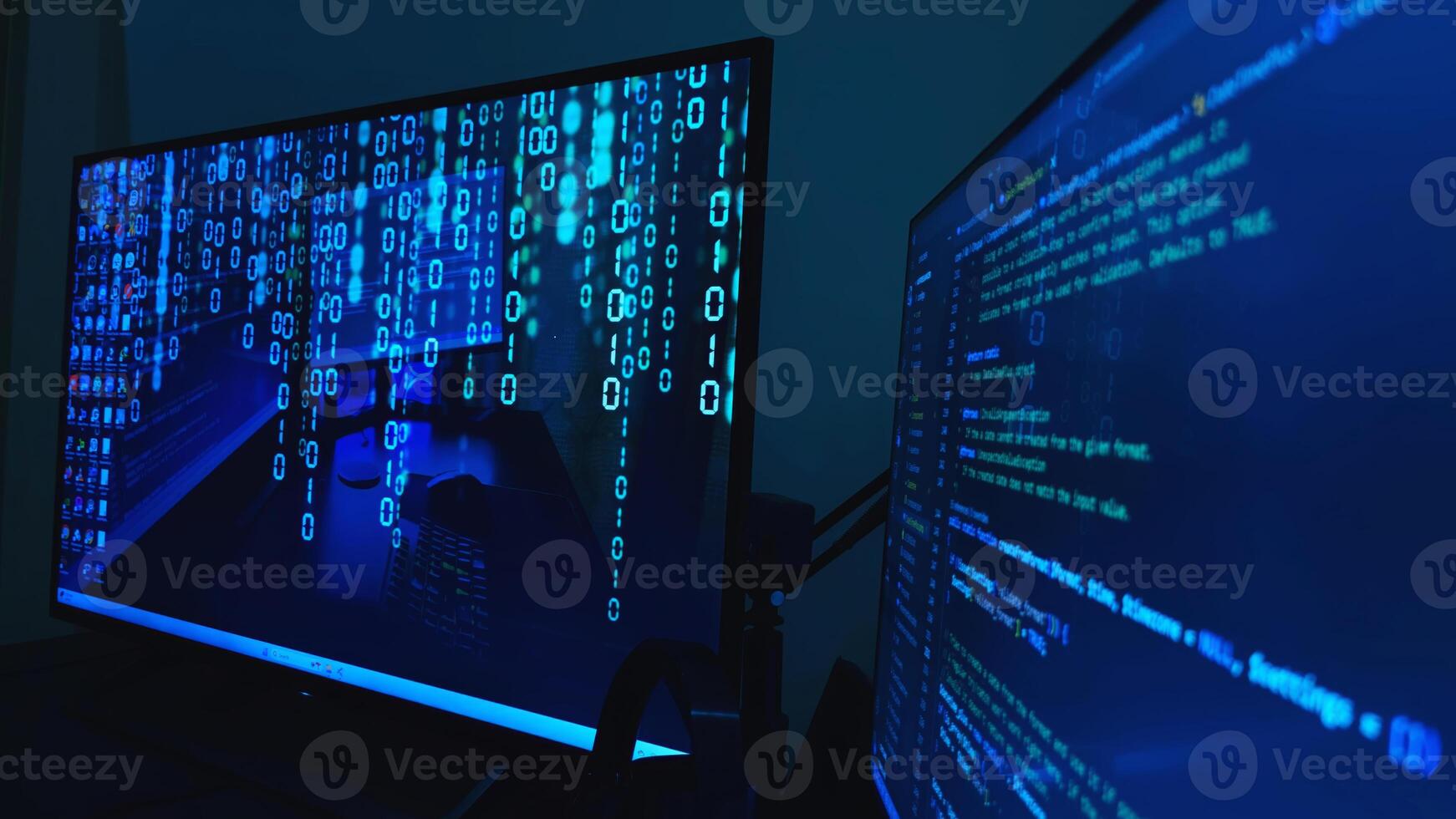 Two monitors with binary code on them photo
