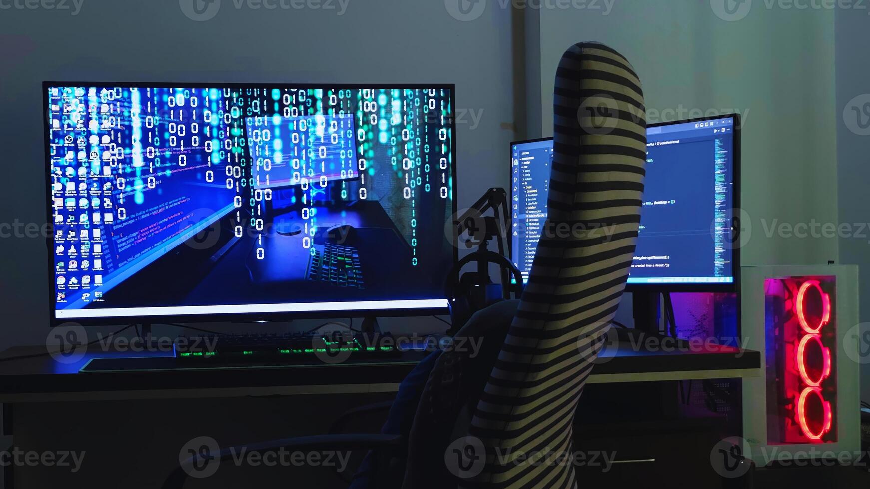 A computer desk with two monitors and a chair photo