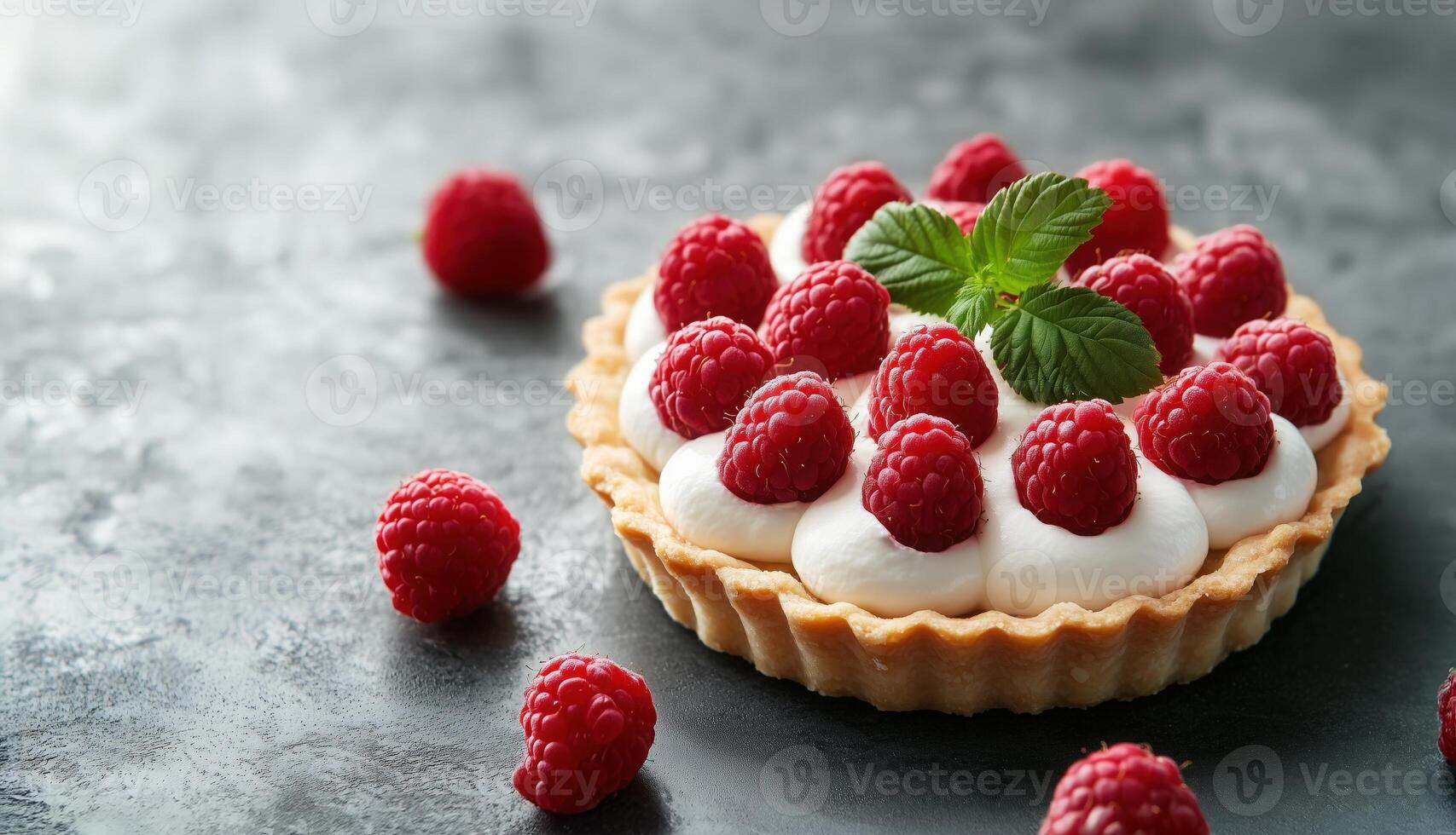 Close-up of bright raspberry tart with cream and fresh raspberries on a table in natural light photo