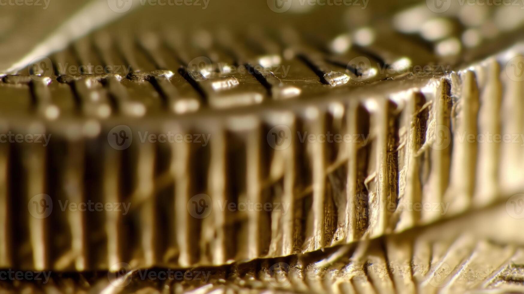 Close-up of coin edge. serrations and detailed texture pattern of golden coins in macro view photo