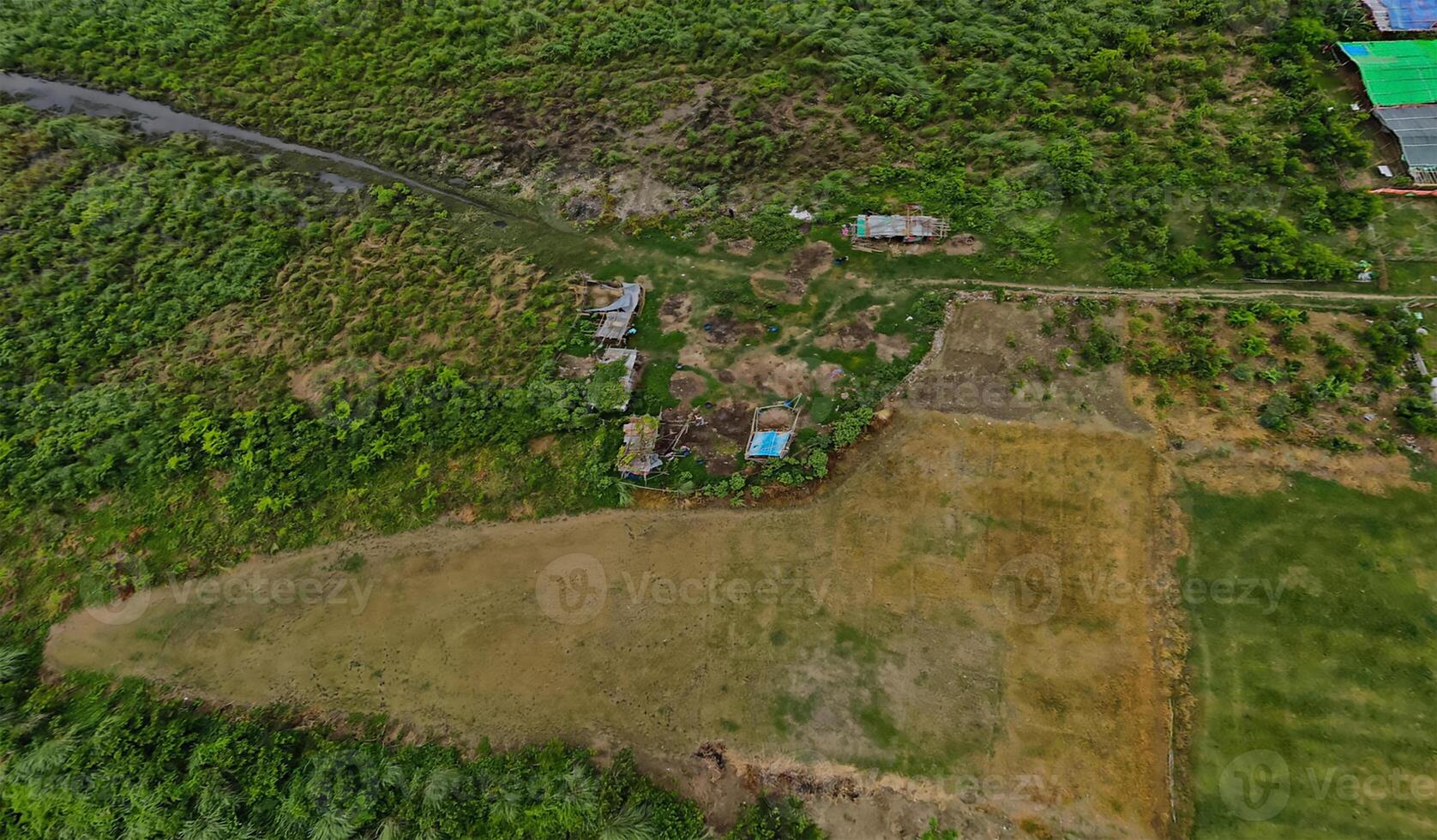 An aerial view of a rural area with houses and trees photo
