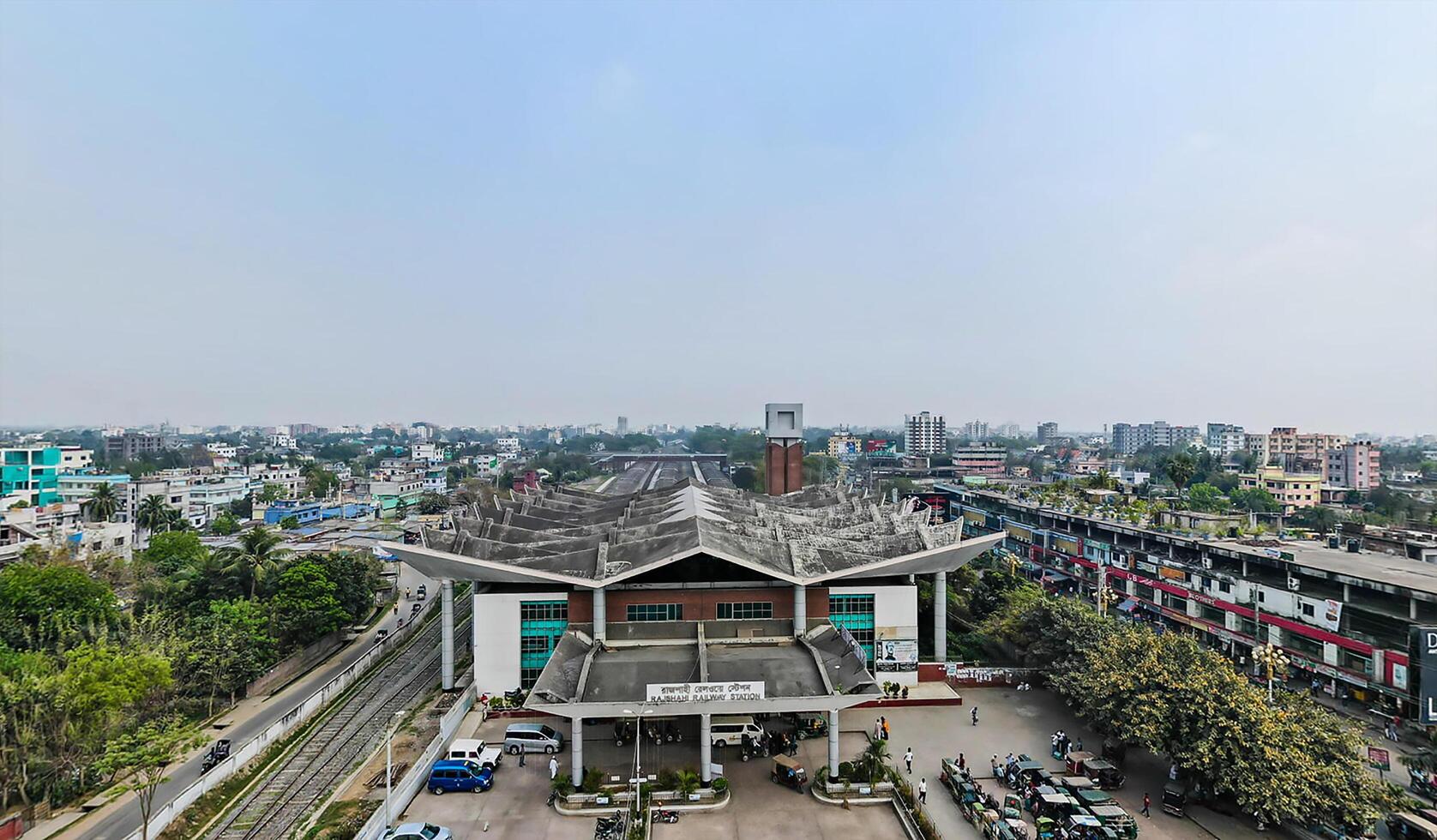 A view of a city from above with a large building photo