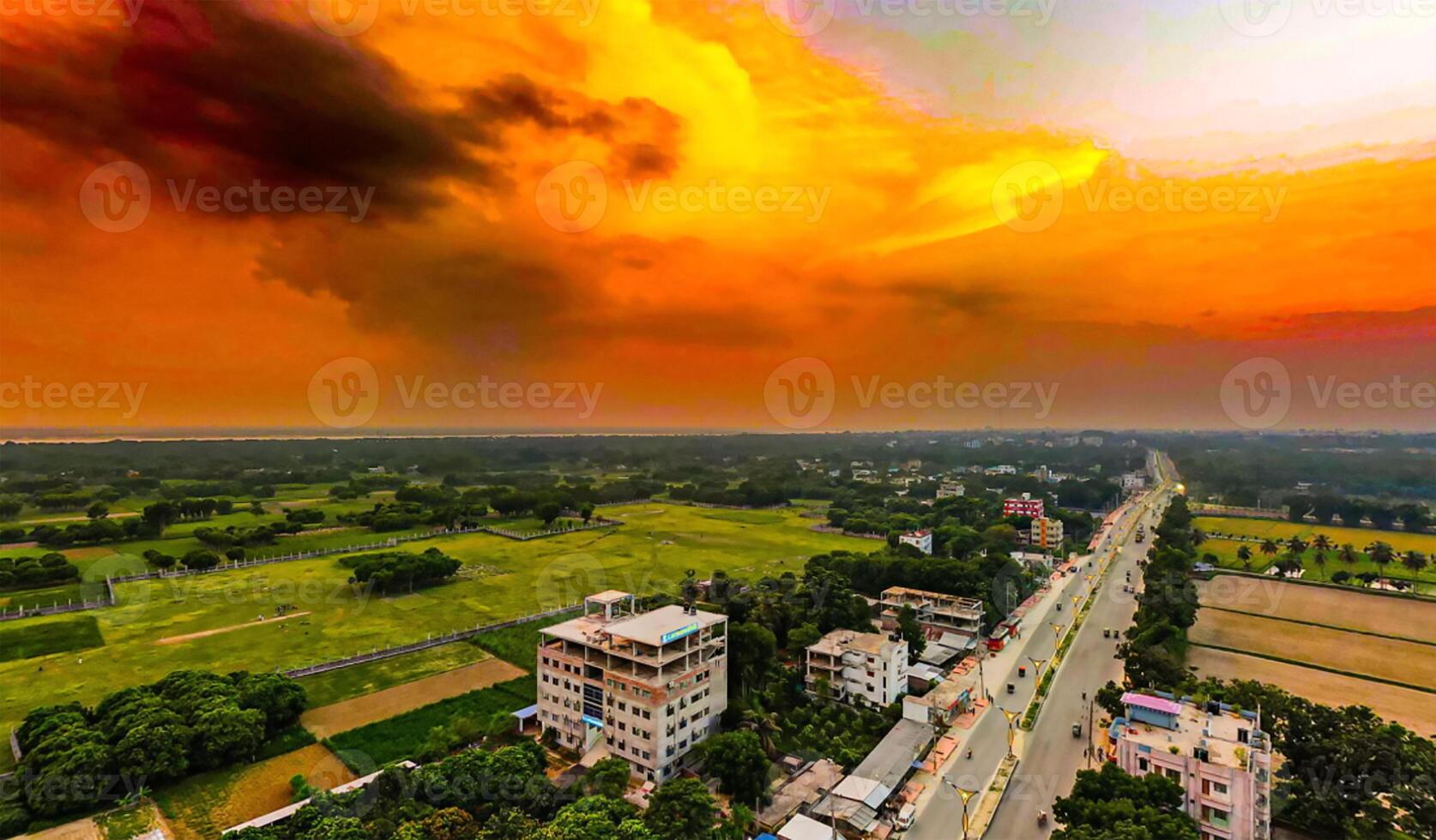 An aerial view of a city with orange clouds photo