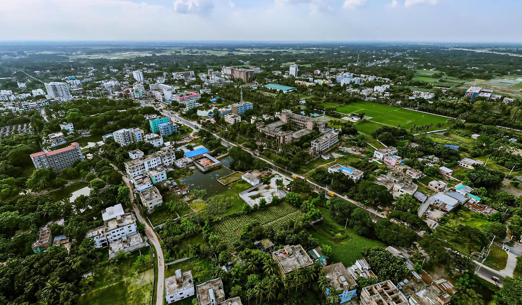 An aerial view of a city with green trees and buildings. photo