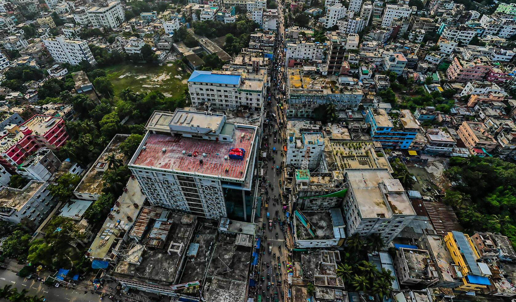 An aerial view of a city with many buildings and the road going into a village. photo