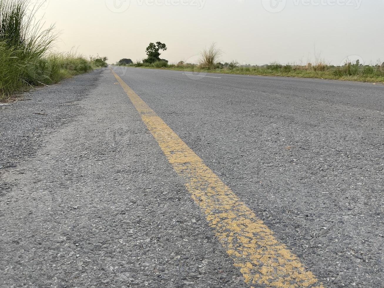 Road between the fields with the sky photo