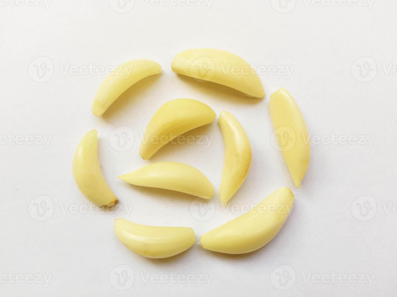 Peeled cloves of garlic isolated on white background - Lehsan Cloves in a circle shape photo