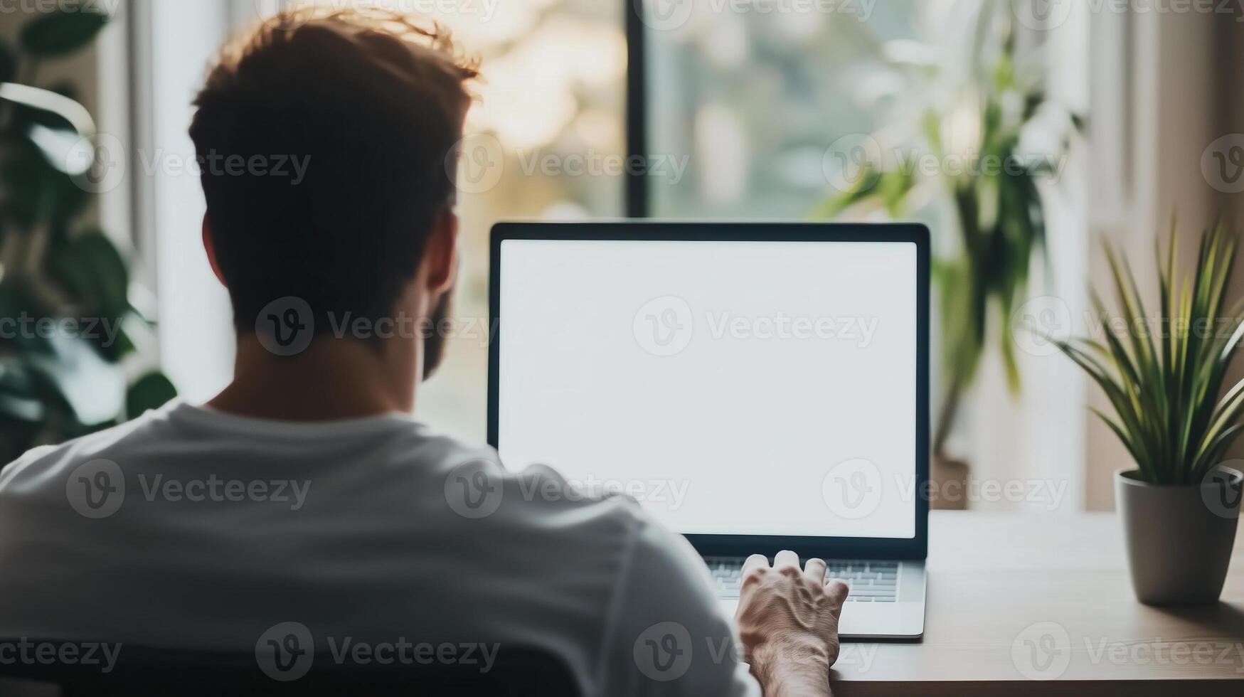 Over shoulder shot of a young man using computer laptop photo