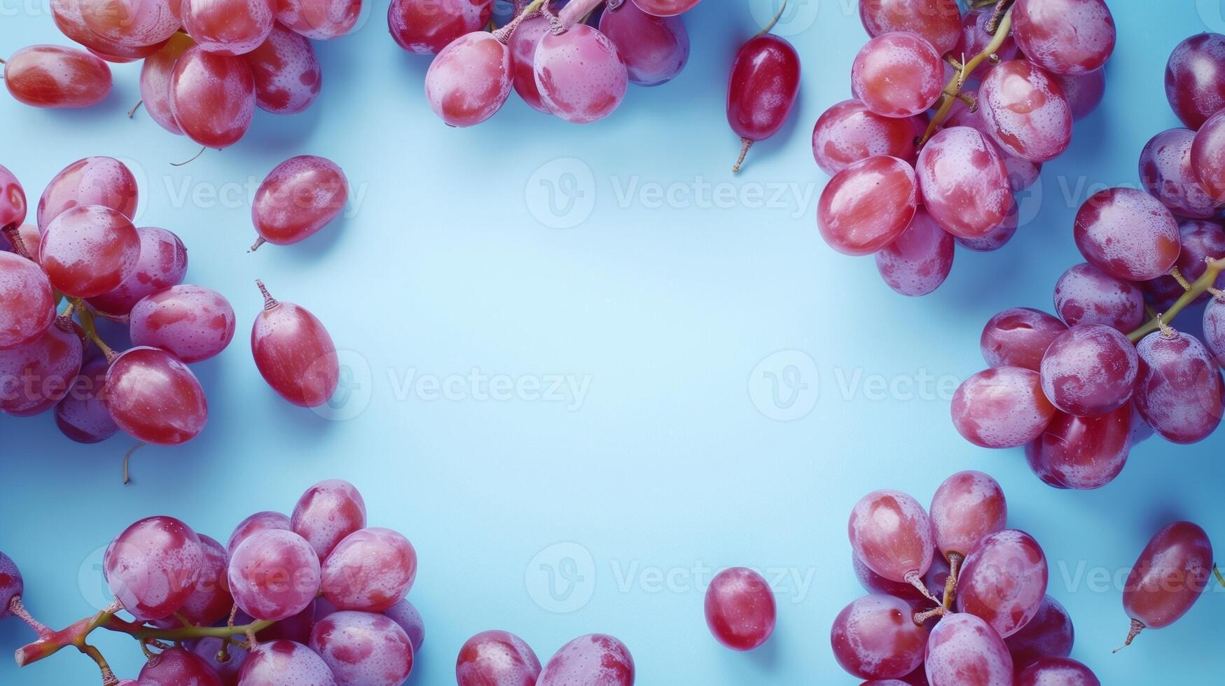 Grape purple fruit circular arrangement copy space black in center blue background photo