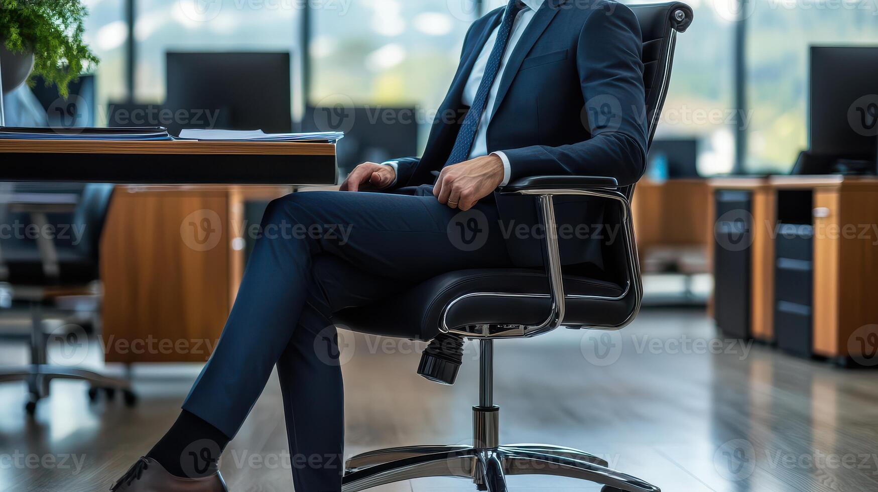 A man in a suit sitting on an office chair photo