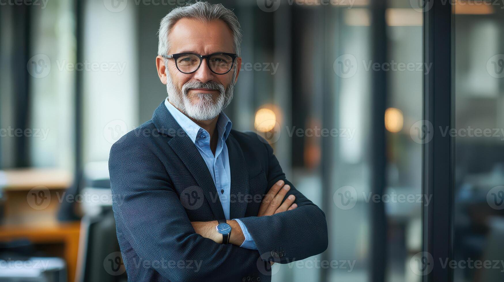 A man with glasses and a beard standing in an office photo