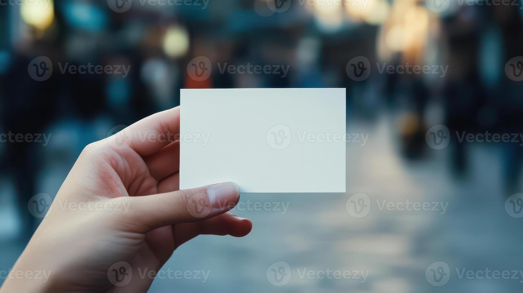 A person holding up a blank piece of paper photo