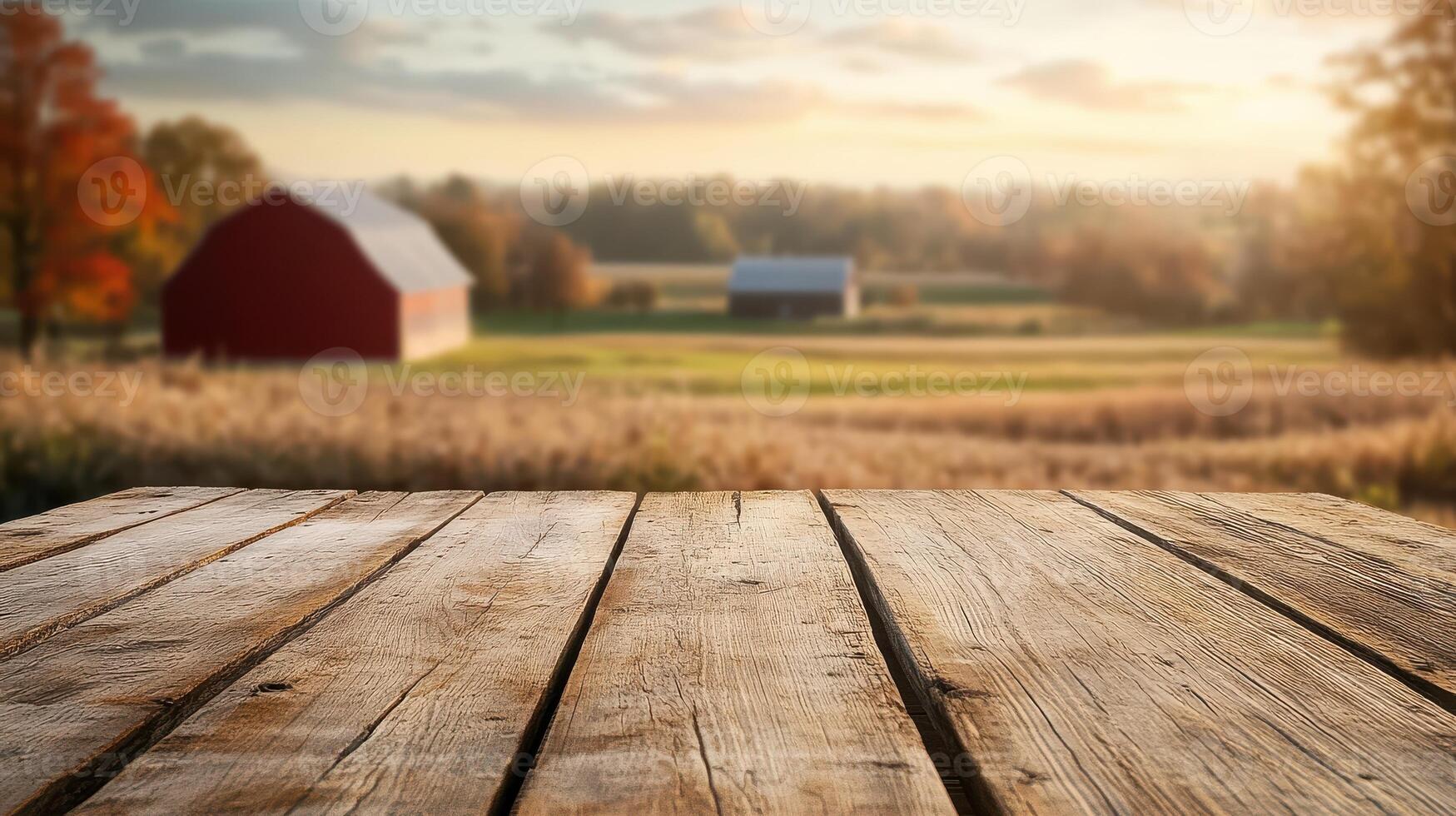 Wooden table top over a field with a barn in the background photo