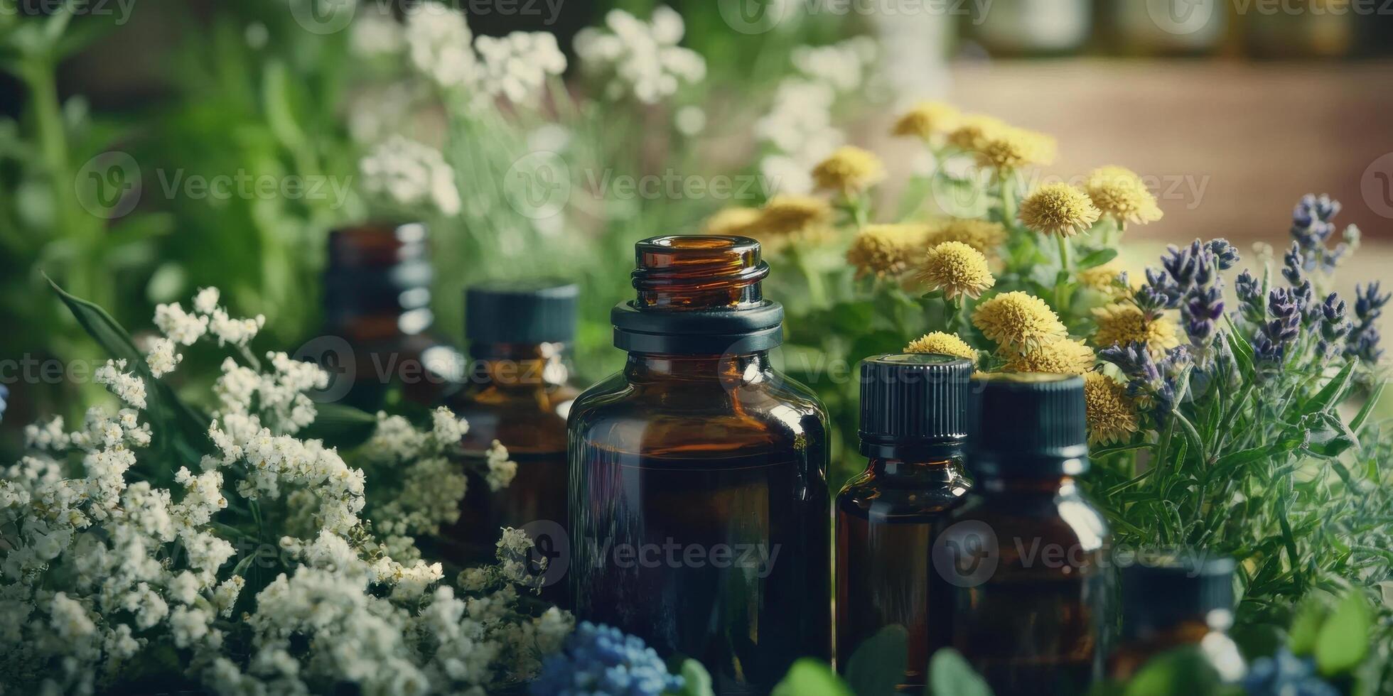 Essential oils and flowers in a glass bottle photo