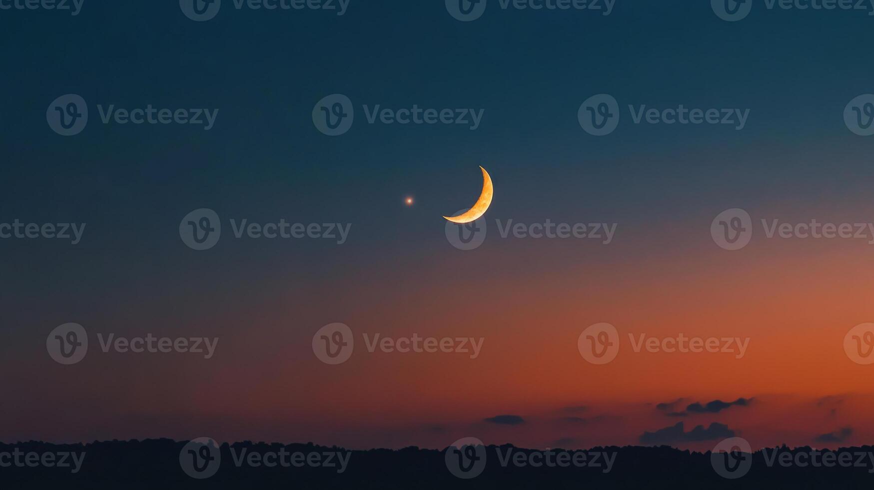 The moon and a crescent are seen in the sky photo