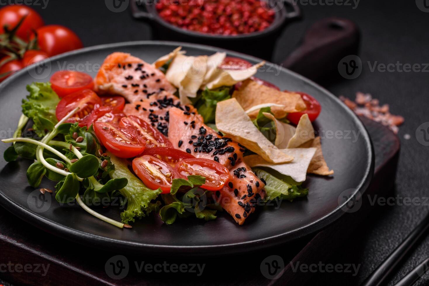 Delicious fresh caesar salad with salmon, lettuce, tomatoes and egg photo