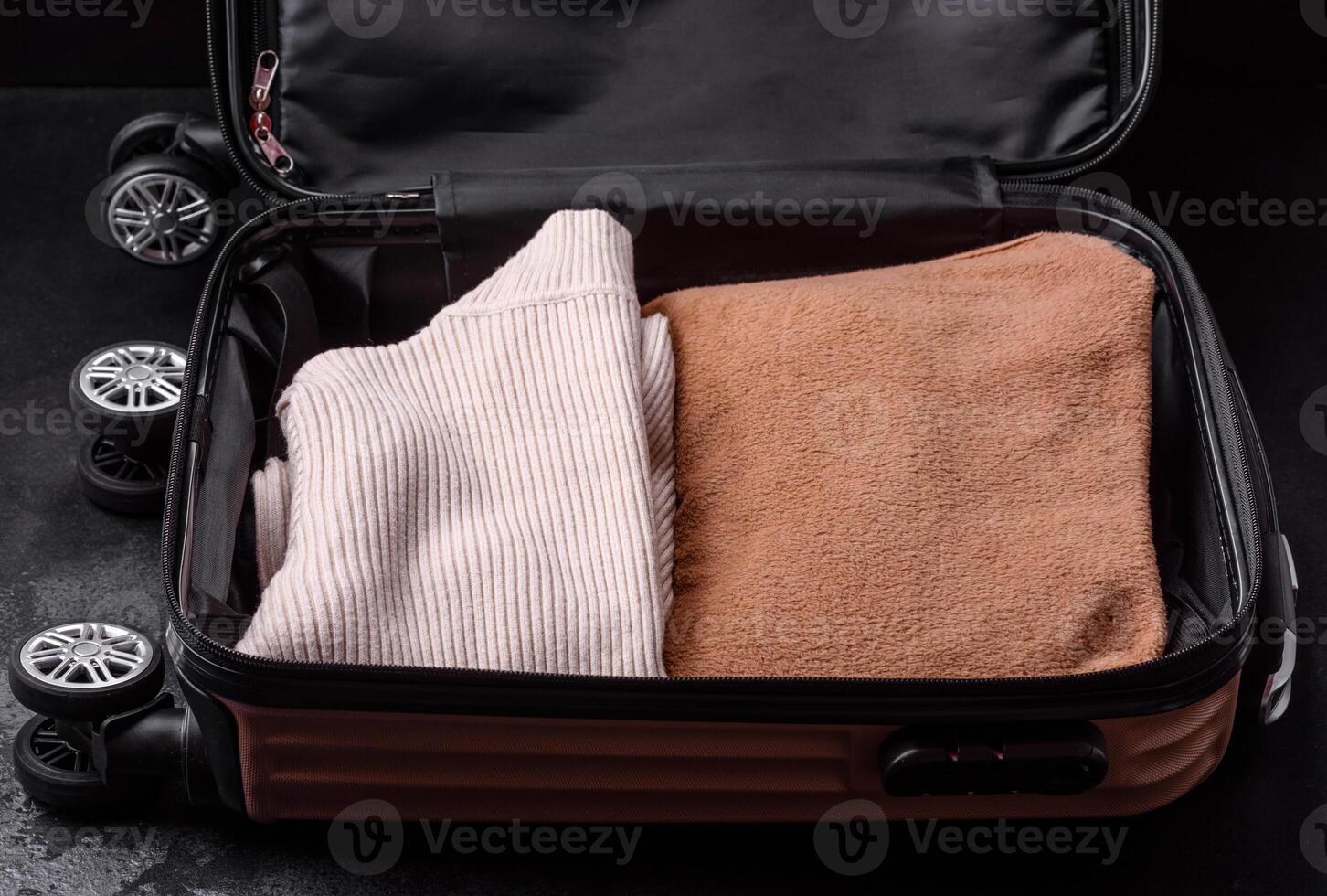 An open suitcase with wheels with clothes inside. Preparing for your trip photo