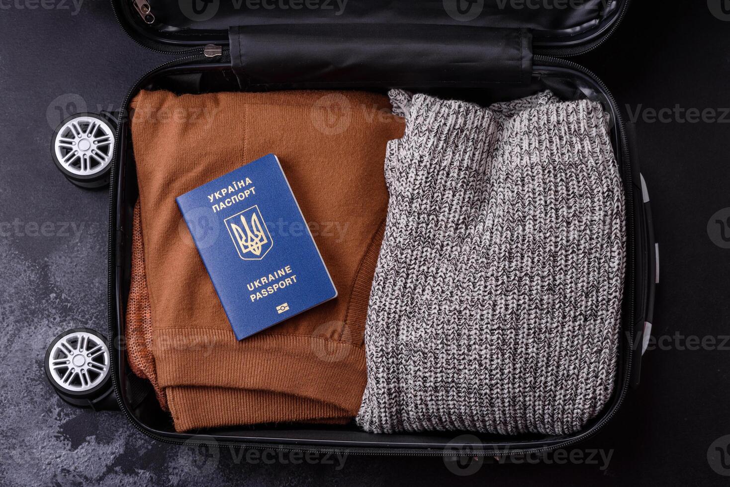 International passport of a citizen of Ukraine on a suitcase photo