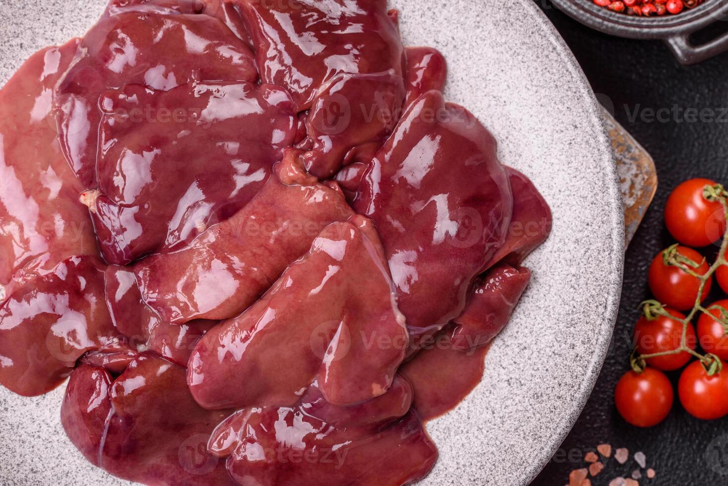 Fresh raw chicken or beef liver with salt, spices and herbs photo
