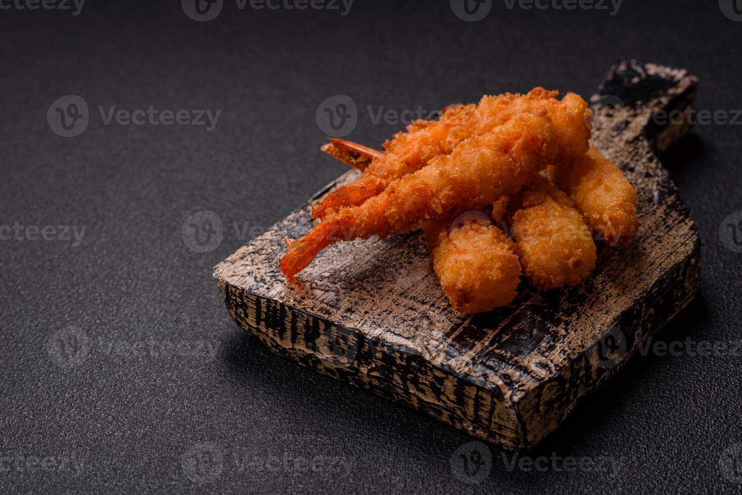 Hot crispy shrimp breaded with salt and spices with white sauce photo