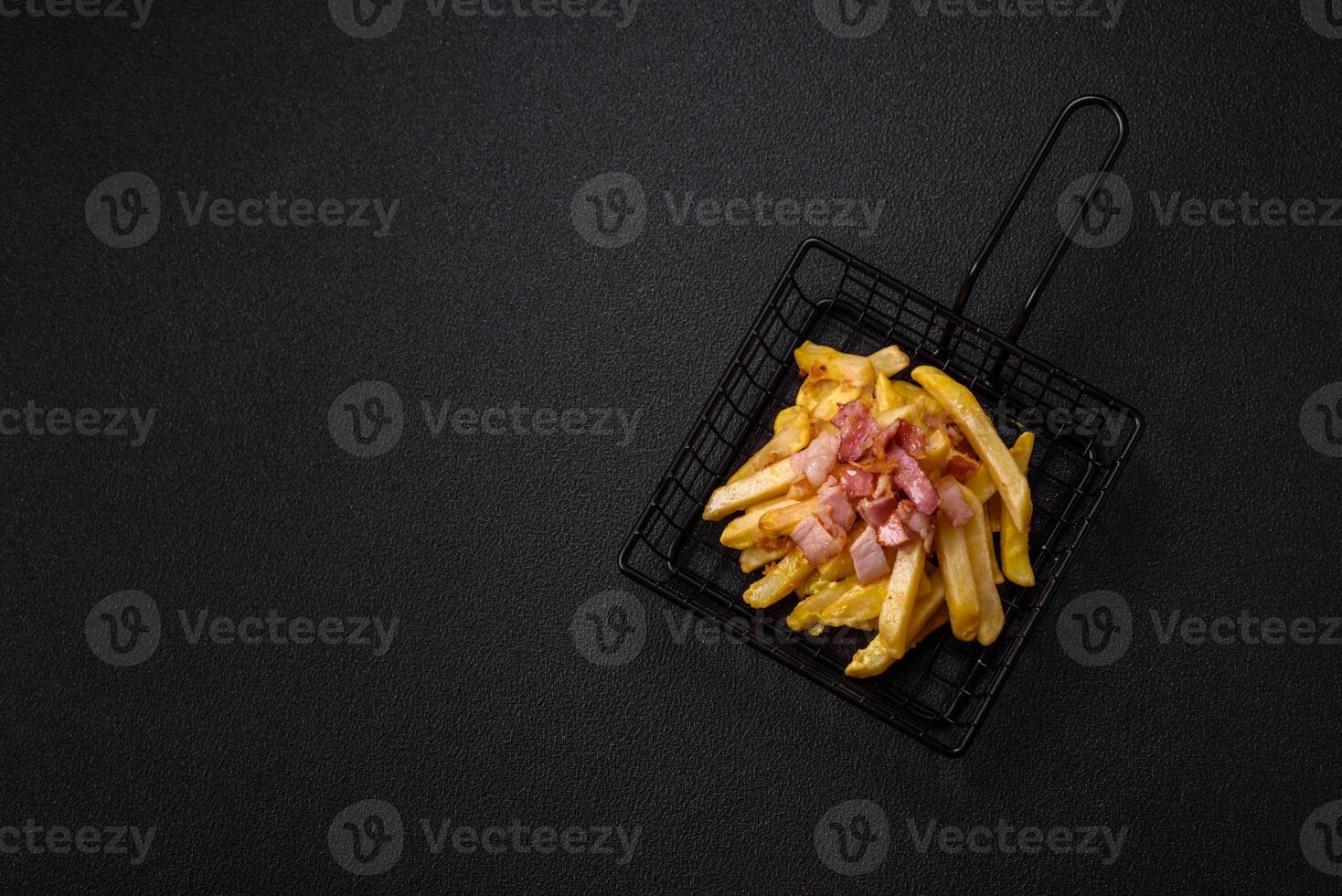 Crispy French fries with pieces of bacon, salt and spices photo