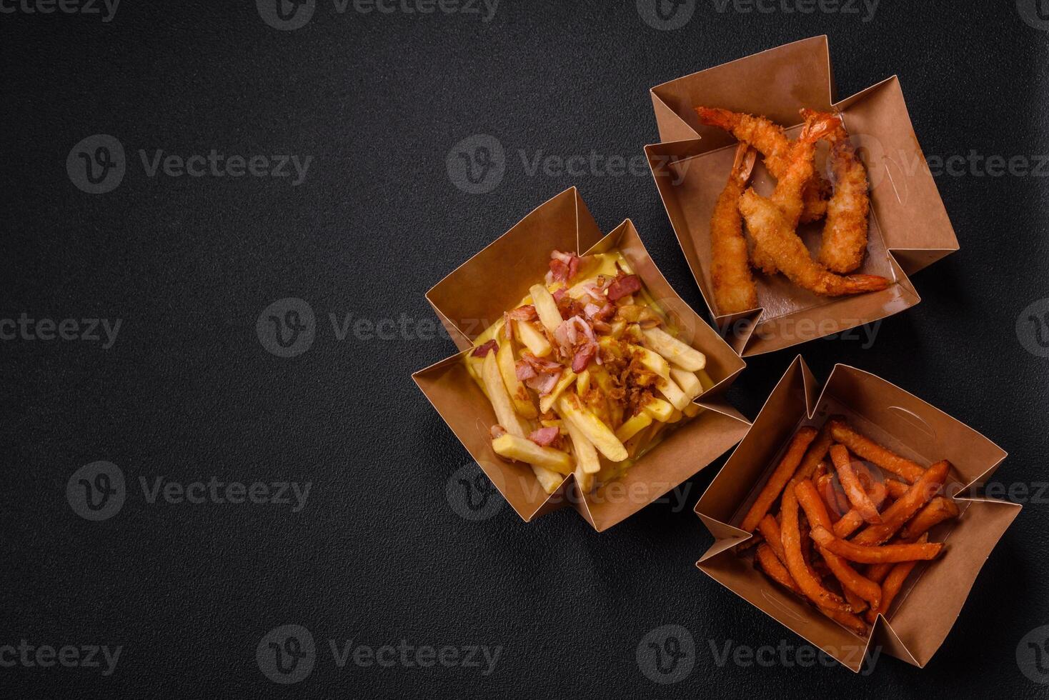 Crispy French fries with pieces of bacon, salt and spices photo