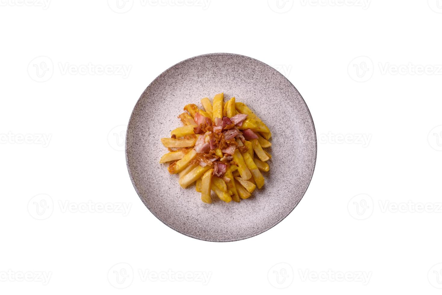 Crispy French fries with pieces of bacon, salt and spices photo